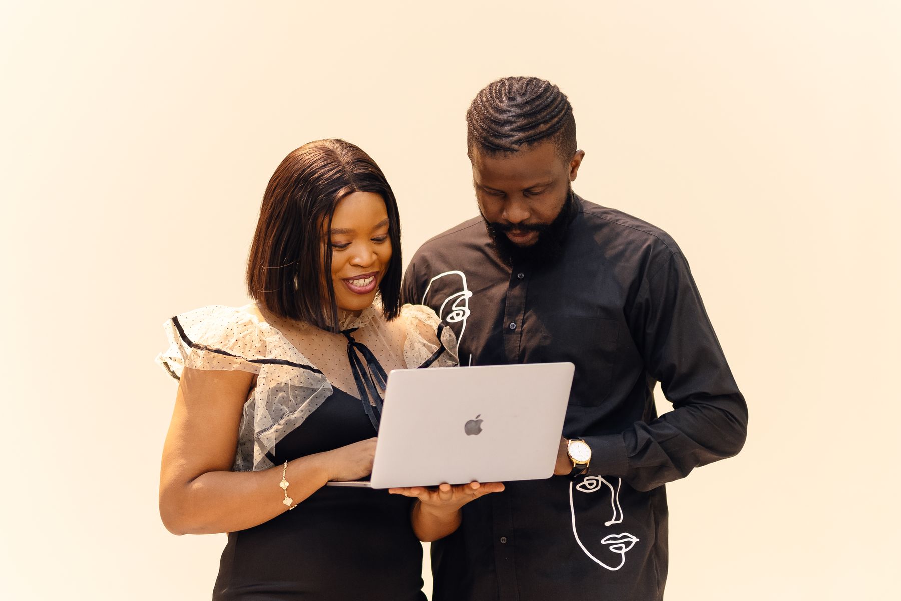 Young adults sharing ideas around a laptop in a workspace